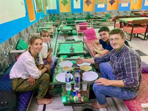 a group of people sitting at a table in a restaurant at Hotel haritage desert safari in Jaisalmer +34 photos