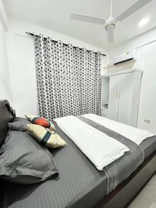 a large bed in a room with a window at Zanzibar Cozy Home in Zanzibar City +8 photos