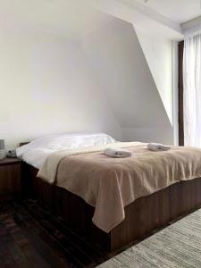 a bedroom with a bed with two pillows on it at Spiky hill resort in Kopaonik