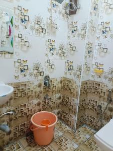 a bathroom with a shower curtain with pictures on the wall at Pure Vegeterian - Private Dormatory - No Alcohol Zone - Hilltop Heaven in Yelagiri