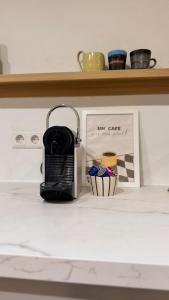 a coffee maker sitting on a counter next to a shelf at Hygge & Schwarzwald - 2 Zimmer Wohnung in Bad Krozingen in Bad Krozingen +6 photos