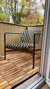 a bench sitting on a deck on a porch at Hygge & Schwarzwald - 2 Zimmer Wohnung in Bad Krozingen in Bad Krozingen