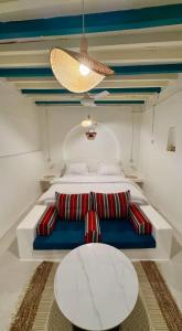 a bedroom with a bed with a blue couch and a table at Casa Blanca - calm space for soul revival in Ādam +81 photos