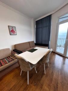 a living room with a table and a couch at 2-х комнатная квартира на берегу моря Колхида in Batumi