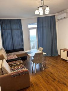 a living room with a couch and a table at 2-х комнатная квартира на берегу моря Колхида in Batumi