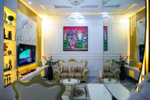 a living room with a couch and a tv at The Peak Residence in Ibadan