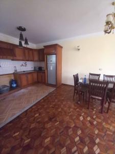 Una sala de estar con mesa y sillas y una cocina. en Guest house, en Addis Ababa