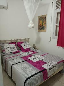 a bed with hello kitty pillows on it in a room at Lantana in Sainte-Anne