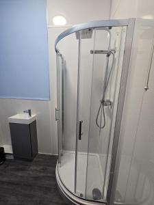 a shower with a glass enclosure in a bathroom at Maqs Bistro in Egremont