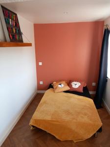 a bedroom with a bed with two pillows on it at Appartement en hyper-centre in Figeac