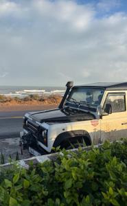 a white and black truck parked on the side of the road at Small functional and impeccable loft facing the sea in Douar el Arbi Ben Ahmed