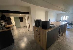 a kitchen with a counter with two televisions on it at Appartement en hyper-centre in Figeac