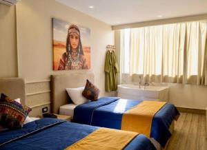 Postel nebo postele na pokoji v ubytování majjesticc INN pyramids view