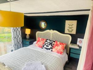 a bedroom with a white bed with pillows at Outlook farm cabin firepit in Hertford