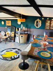 a room with two beds and a table and a sink at Outlook farm cabin firepit in Hertford