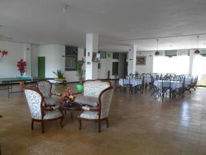 a large room with tables and chairs and a room with tables and chairs at Gran Hotel El Cedro in Girardot