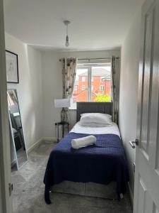 a small bedroom with a bed and a window at Margam's Gloucester House for Business Travellers in Cheltenham