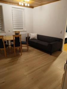 a living room with a couch and a table at Apartment with 4 Rooms in Golling +11 photos