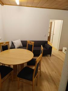 a living room with a couch and a table and chairs at Apartment with 4 Rooms in Golling