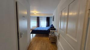 a small bedroom with a bed and a hallway at Geluk in Bettingen in Bettingen