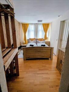 a bedroom with a large bed with yellow curtains at Töpferhäuschen Tangermünde in Tangermünde