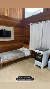 Ένα ή περισσότερα κρεβάτια σε δωμάτιο στο Chalés De Luxe Gramado