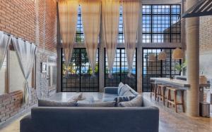 a living room with a couch and a table at Summer Salt Beach Casita in Punta Mita