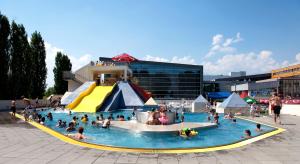 a group of people in a pool at a water park at Apartmány Renomal in Vysoke Tatry - Tatranska Lomnica.