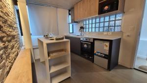 a small kitchen with a stove and a sink at 1902Aparts in Montevideo