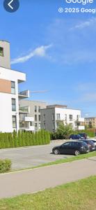 two cars parked in a parking lot next to a building at Panorama Biegusa 74 in Gliwice