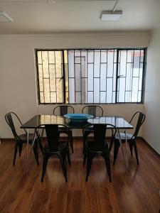 a room with two tables and chairs with stained glass windows at Casa Quinta Vergara in Viña del Mar +9 photos