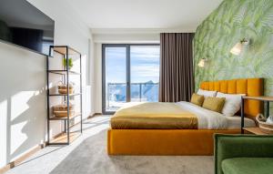 a bedroom with a bed and a large window at New Gudauri Apartments in Twins in Gudauri