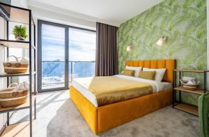 a bedroom with a bed with a green wall at New Gudauri Apartments in Twins in Gudauri +12 photos