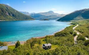a view of a lake with a house next to it at Aurora Suite in Tromsø