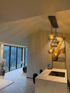 a living room with a table and a painting on the wall at Aurora Suite in Tromsø