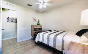 a bedroom with a bed and a table in it at Cozy 4 BR Abode in Jacksonville