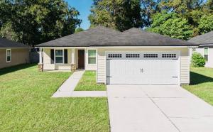 a house with a garage in a yard at Cozy 4 BR Abode in Jacksonville