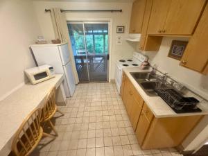 a kitchen with a white refrigerator and a sink at Ocean Breeze Motel in Florence