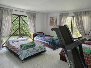 a room with two beds and a large window at Casa de recreo en conjunto residencial in Arbeláez +31 photos