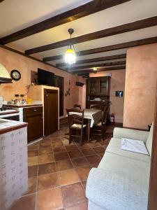 une cuisine et un salon avec une table dans l'établissement Charme Rustico 70 mt from the beach, starlink, à Cefalù 2 autres photos