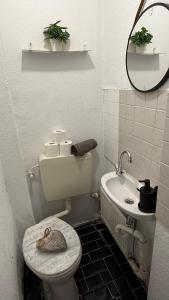 a small bathroom with a toilet and a sink at CCH comfort Bremerhaven in Bremerhaven