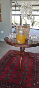 a glass of orange juice sitting on a table at Achab Camping Camp site in Usakos