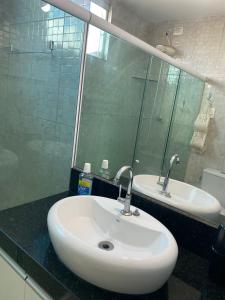 a bathroom with a white sink and a mirror at Casa - Candeias- Jaboatão dos Guararapes in Recife +6 photos