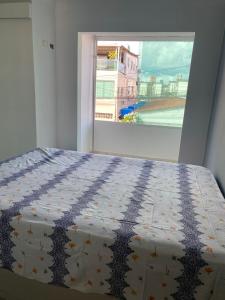 a bedroom with a bed and a window with a view at Casa - Candeias- Jaboatão dos Guararapes in Recife