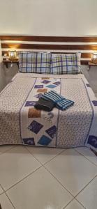 a bed with a blanket and pillows on it at Cores de Boipeba in Ilha de Boipeba