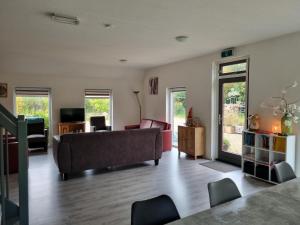 a living room with a couch and a table at Vakantiewoning Stuifzand in Stuifzand