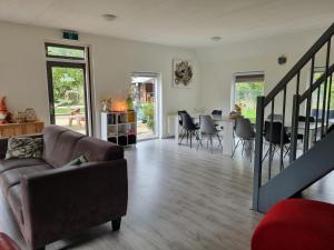 a living room with a couch and a table at Vakantiewoning Stuifzand in Stuifzand