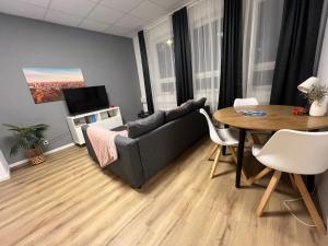 a living room with a couch and a table at Neu Studio Leipzig Zentrum in Leipzig