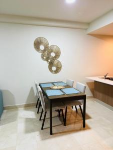 a dining room with a table and some chairs at Garden View Condo 221 Marien Beach Resort Pool Access in Puerto Plata