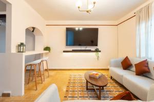 a living room with a couch and a tv at Casa 906 in Puebla